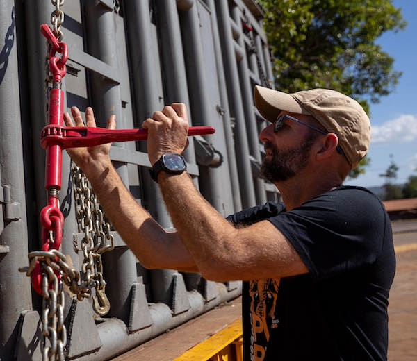 Photo of GSE co-founder Scott Blais tightening the chains holding down the transport crate carrying Kenya, a female African elephant, to Elephant Sanctuary Brazil